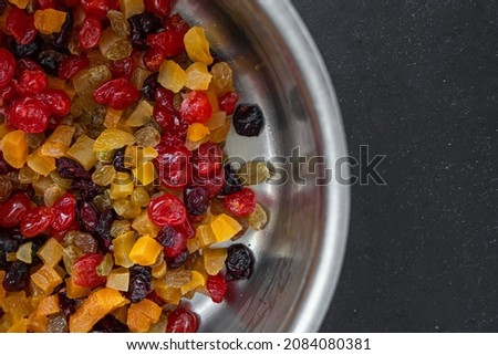 Stollen and muffin filling. Mix of dried berries and fruits. Candied yellow and red fruits. Appetizing picture for kitchen and restaurant. Christmas food. Juicy colors of food.