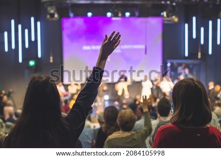 Hands in the air of people who praise God at church service Royalty-Free Stock Photo #2084105998