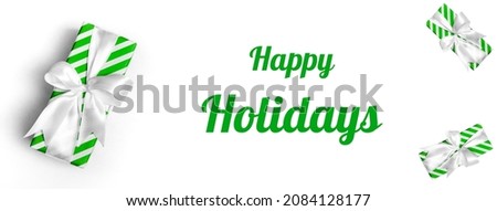 Striped gift box with a green bow on a white background. Close up of a banner with text