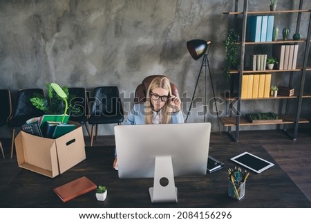 Photo of focused marketer economist boss chief lady packed box use modern technology search web pages vacancy in workspace