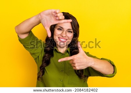 Photo of confident lady make frame gesture prepare make selfie wear specs green shirt isolated yellow color background