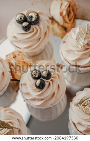 Cakes with creamy white cream and blueberries, top view, close-up, mirrored