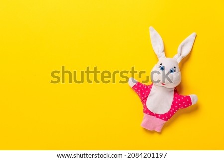 Banner with Easter bunny isolated on yellow background with copy space, empty text place. Education toy theater online course. Hand puppet. Sewing hobby. Fairy tale character. Fluffy baby play friend.