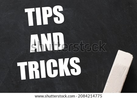 TIPS AND TRICKS words on a black chalk board.