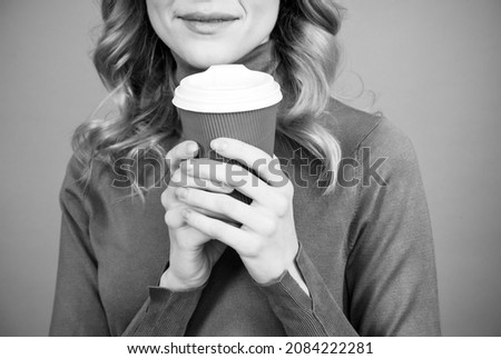 Woman cropped view hold hot cup of fresh aromatic morning drink grey background, aroma