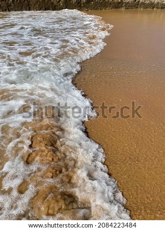 Picture of waves crashing onto the shore, located in Praia de Carcavelos