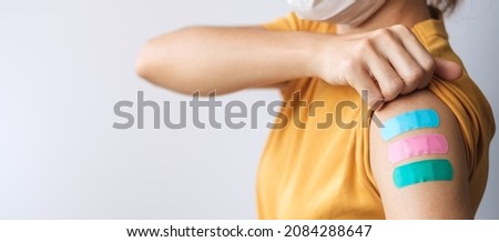 woman showing plaster after receiving covid 19 vaccine. Vaccination, herd immunity, side effect, booster dose, vaccine passport and Coronavirus pandemic Royalty-Free Stock Photo #2084288647