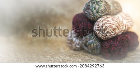 Vintage Knitting needles and yarn on wooden background. natural wool knitting background. knitting yarn for handmade winter clothes. Close Up of yarn balls. Rainbow colors.  Place for text, banner. Royalty-Free Stock Photo #2084292763