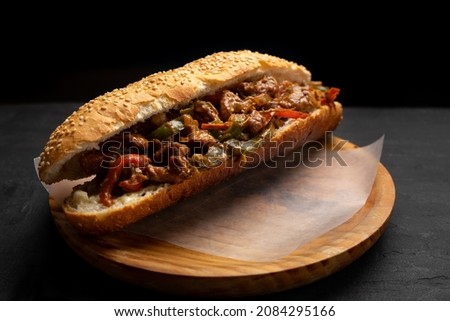 Traditional philly cheese steak with bell pepper on dark background Royalty-Free Stock Photo #2084295166