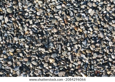 The texture of coarse gravel in full screen as a background. View from above