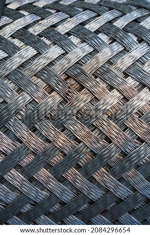 Metallic texture of steel herringbone weave. Whole screen, close-up