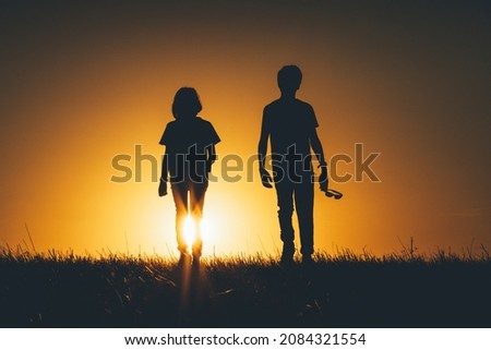 Kids are walking together at sunset