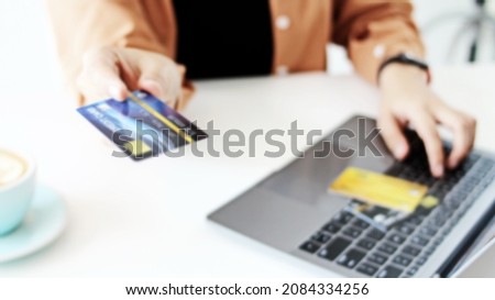  Woman hand has a credit card,Online shopping,blurry pictures for background