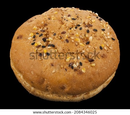 Burger bun isolated on black background. Detail for design. Design elements. Macro. Full focus. Background for business cards, postcards and posters. Food object design. 