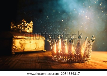 low key image of beautiful queen or king crown and gold treasure chest. vintage filtered. fantasy medieval period Royalty-Free Stock Photo #2084384317
