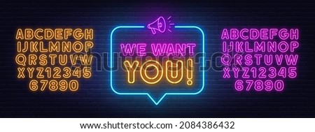 We want you neon sign in the speech bubble on brick wall background. Royalty-Free Stock Photo #2084386432