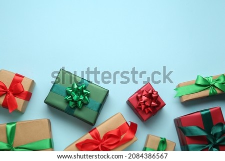 Many gift boxes on light blue background, flat lay. Space for text