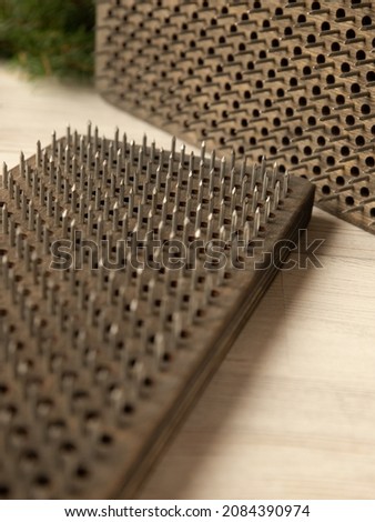 Woood brown Sadhu board, Bed of Nails. Yogic exercise. Fire Meditation Boards. Yoga desk. Close-up, vertical photo