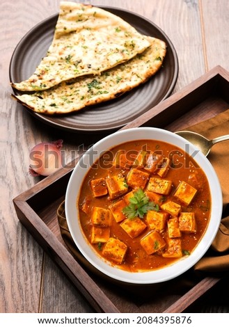 Paneer Butter Masala with garlic naan tasty indian food. Punjabi Food, Desi Food. Royalty-Free Stock Photo #2084395876