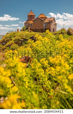 Vertical photo of the famous ancient monastery of Hayravank in Armenia with the legendary Lake Sevan in the background. Travel attractions concept