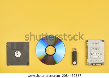 Various storage media, floppy disk, disk, flash drive and hard disk, copy space. Royalty-Free Stock Photo #2084437867