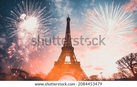 Holiday background - Eiffel tower with fireworks, celebration of the New Year in Paris, France