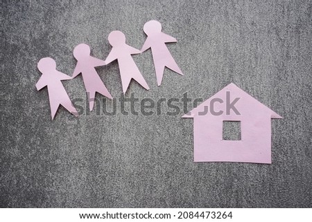 Four paper figure people in front of home paper. its can use for home invesment photo concept
