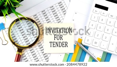 INVITATION FOR TENDER text on sticker on diagram with magnifier and calculator. Business