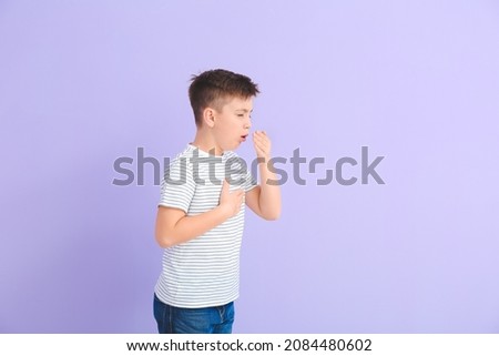 Coughing little boy on color background Royalty-Free Stock Photo #2084480602