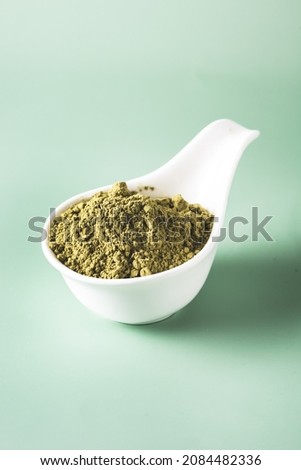 White Bowl with Green Matcha Powder Pink Background Vertical