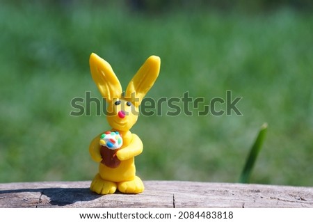Easter bunny with a cake in his hands. The symbol of Easter.