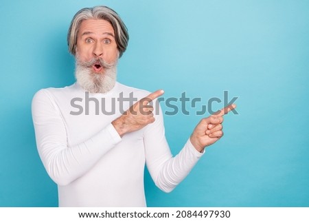 Portrait of attractive amazed grey-haired man demonstrating copy blank space ad advert look idea isolated over bright blue color background