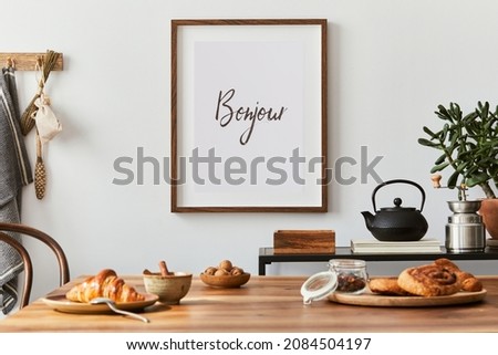 Creative and modern dining room interior design with mock up poster frame, family dining table, black console and retro inspired personal accessories. Copy space. Template. Autumn vibes.
