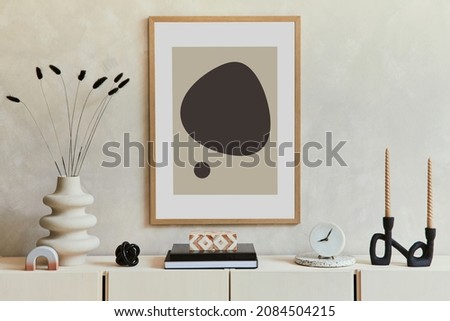 Stylish and modern beige living room interior composition with mock up poster frame, beige wooden sideboard and boho inspired accessories. Template.
