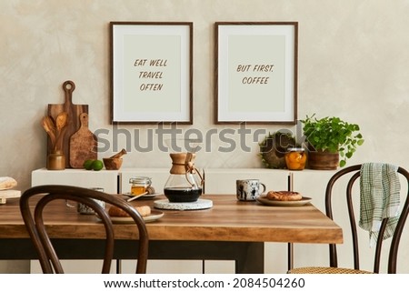 Elegant composition of stylish dining room intrerior with mock up poster frames, beige sideboard, family dining table, plants and vintage personal accessories. Copy space. Template. Autumn vibes.