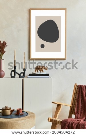 Stylish composition of modern living room interior with mock up poster frame, wooden sideboard, rattan armchair and boho inspired accessories. Template.