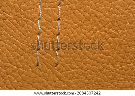 texture of natural aniline leather with decorative seams