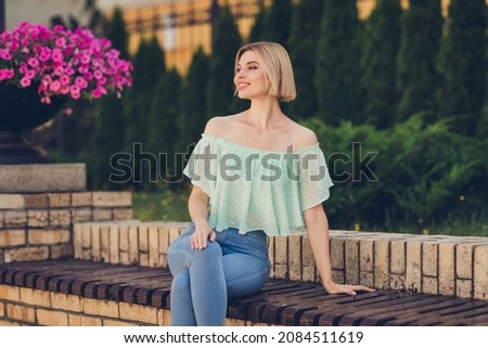 Photo of sweet young blond lady look wear green blouse jeans outsite in park