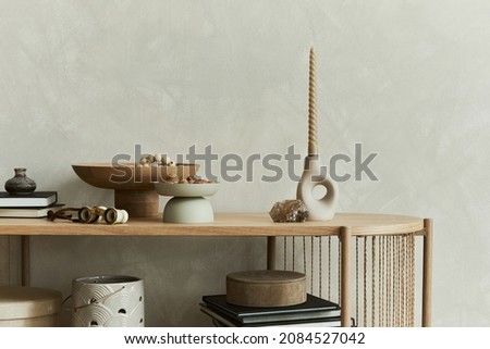 Creative composition of stylish living room interior. Candlectick, trays and personal accessories. Copy space. Template.