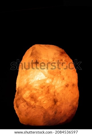 Salt lamp glowing in the darkness