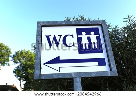 Directional sign for a public restroom for men and women