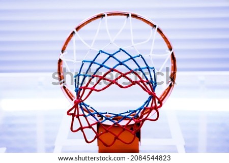 Basketball ring with grid of Russian tricolor. Basketball net with colors of Russian flag. Domestic championship or basketball league of Russia. Background