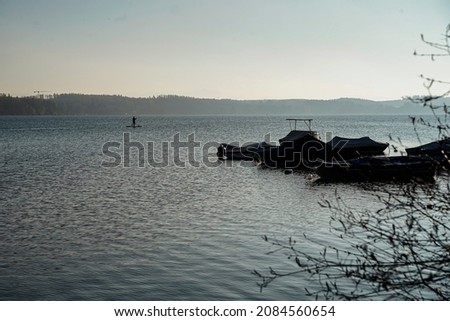 Lonely boats on a lake in winter in sunshine.