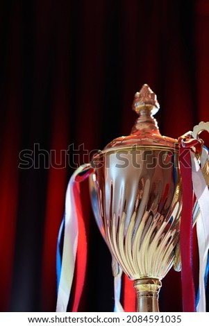 trophy against stage red light on curtain as background