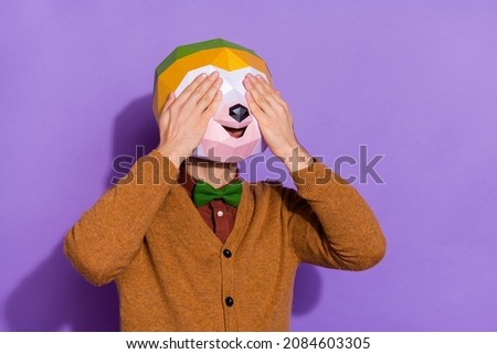 Photo of young man cover eyes arms have fun playful fooling surreal isolated over purple color background