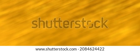 Golden yellow blurred gradient background. Mixed motion texture. Diagonal lines. Abstract defocused header. Wide screen wallpaper. Panoramic web banner with copy space for design
