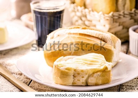 bread with butter and black coffee. Brazilian typical French bread with strong coffee cup, punctual focus on the toasted slice Royalty-Free Stock Photo #2084629744
