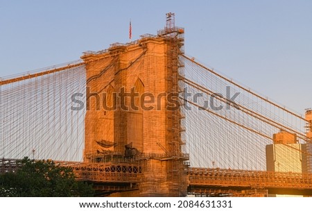 Travel to New York. The skyline of Manhattan photographed during a summer sunrise, view to Brooklyn Bridge. Landmarks of United States of America. Skyscraper office buildings.