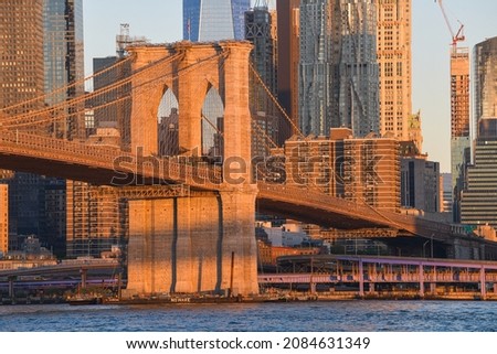 Travel to New York. The skyline of Manhattan photographed during a summer sunrise, view to Brooklyn Bridge. Landmarks of United States of America. Skyscraper office buildings.