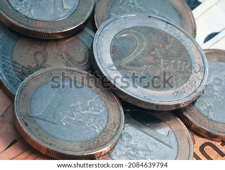 Several euro coins, in this case placed on a grey and dark green background